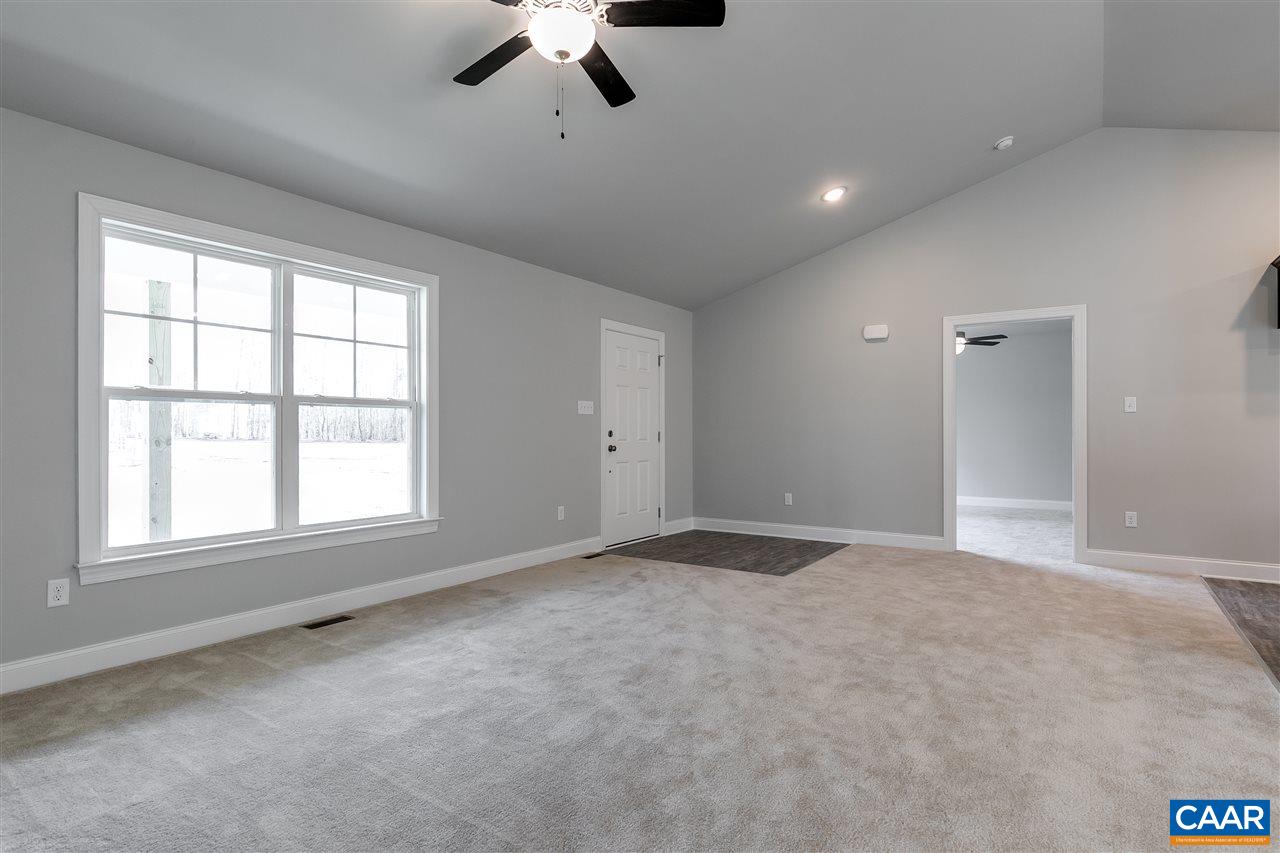 2581 Bumpass Road Beaverdam, VA 23015 - Photo 4 of 16 an empty room with a chandelier fan and windows