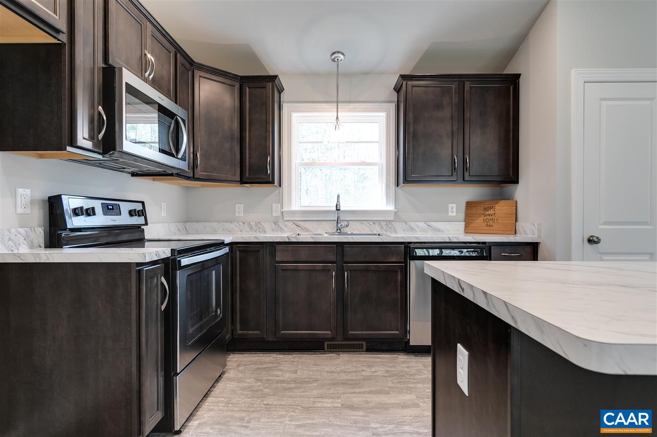 2581 Bumpass Road Beaverdam, VA 23015 - Photo 8 of 16 a kitchen with stainless steel appliances granite countertop a stove microwave and sink