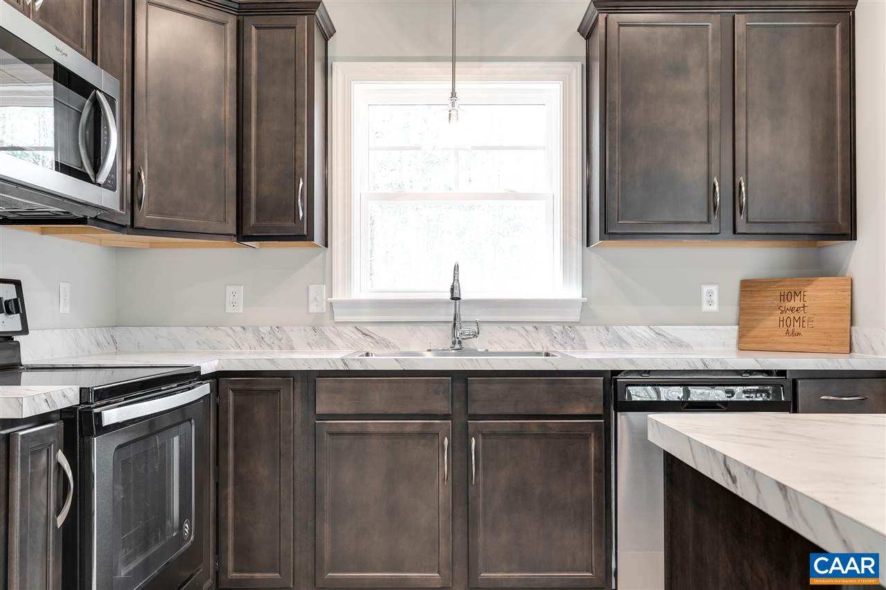 2581 Bumpass Road Beaverdam, VA 23015 - Photo 9 of 16 a kitchen with stainless steel appliances granite countertop a sink and a microwave