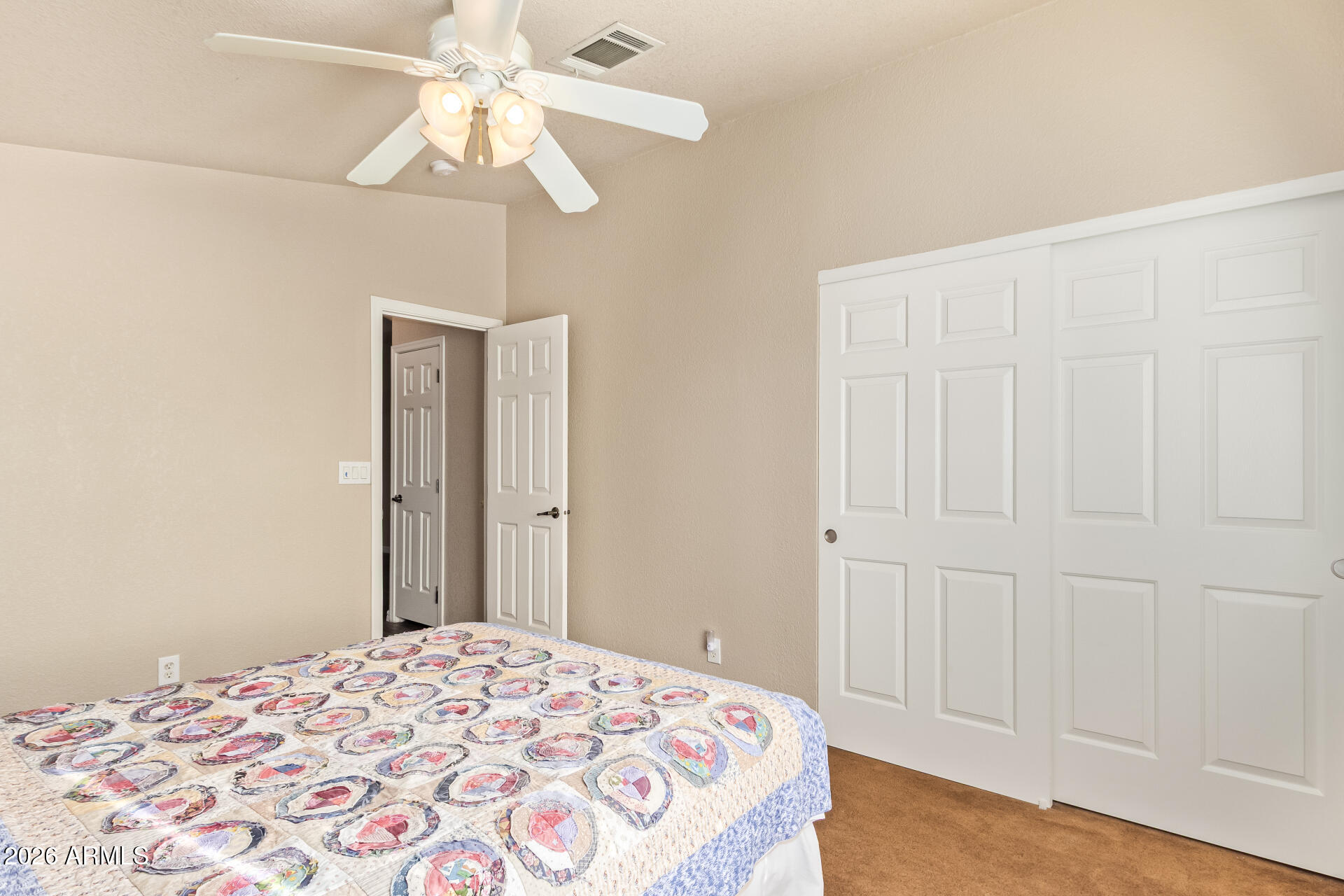 3301 South Goldfield Road, Unit 4028 Apache Junction, AZ 85119 - Photo 25 of 43 a bedroom with a bed and a chandelier