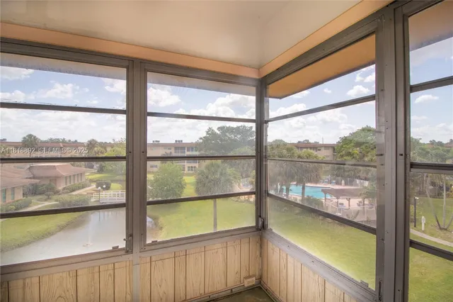 a view of a glass door with a lake from a window