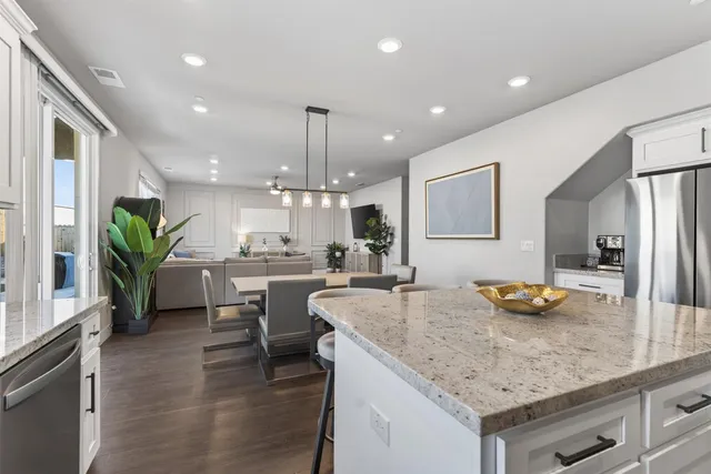 a kitchen with a counter top appliances and cabinets