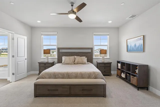 a spacious bedroom with a bed and a chandelier