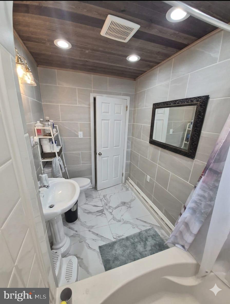 110 High Street Hamilton, NJ 08611 - Photo 15 of 29 a bathroom with a sink a toilet and shower