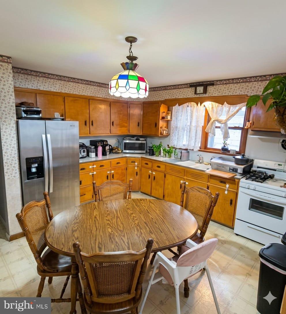 110 High Street Hamilton, NJ 08611 - Photo 9 of 29 a view of a dining room with furniture a chandelier and large windows