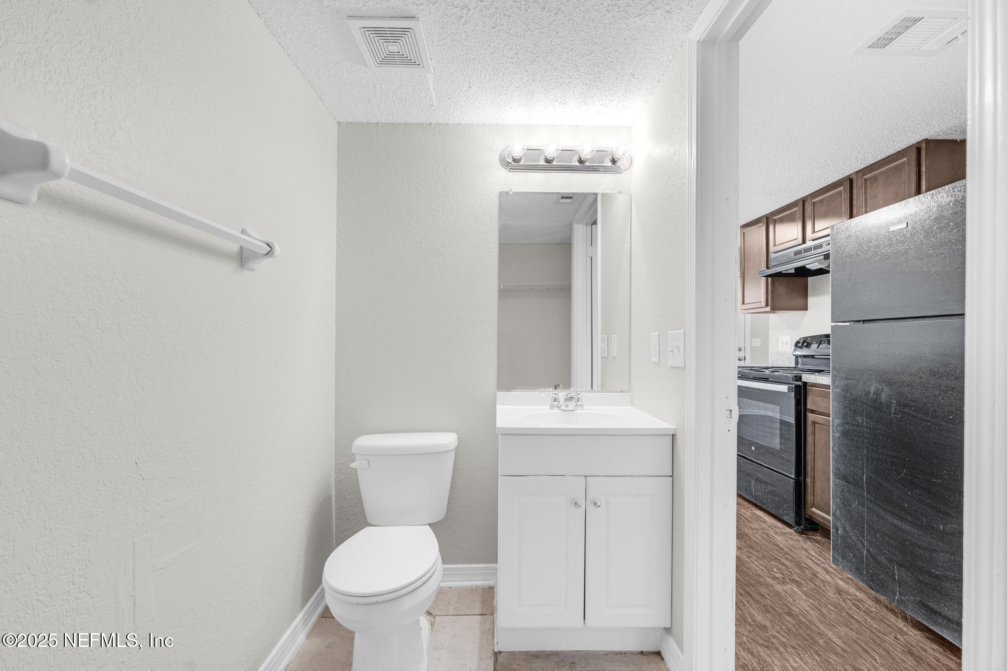 791 Assisi Lane, Unit 1503 Jacksonville, FL 32233 - Photo 12 of 25 a bathroom with a toilet sink and shower