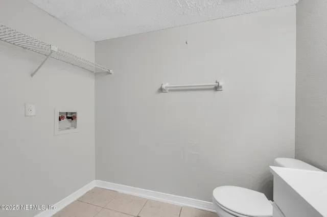 a white toilet sitting next to a shower