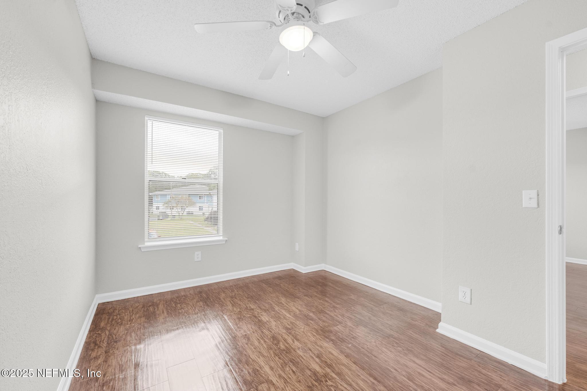 791 Assisi Lane, Unit 1503 Jacksonville, FL 32233 - Photo 15 of 25 an empty room with wooden floor and windows