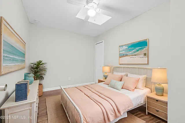 a bedroom with bed and a potted plant