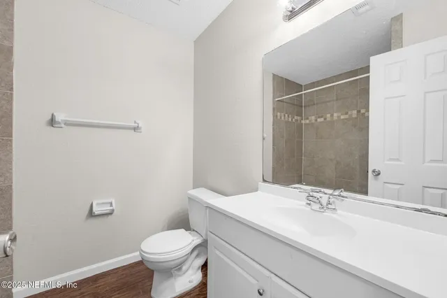 a bathroom with a sink toilet and a mirror
