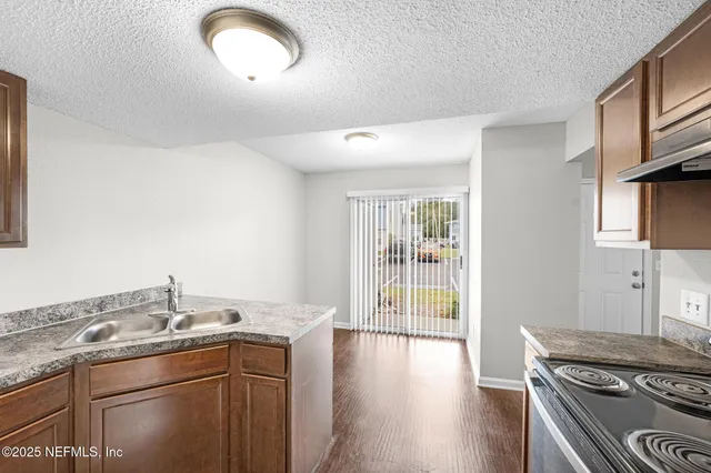 a kitchen with stainless steel appliances granite countertop a stove and a sink