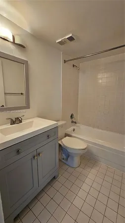 a bathroom with a double vanity sink toilet and shower