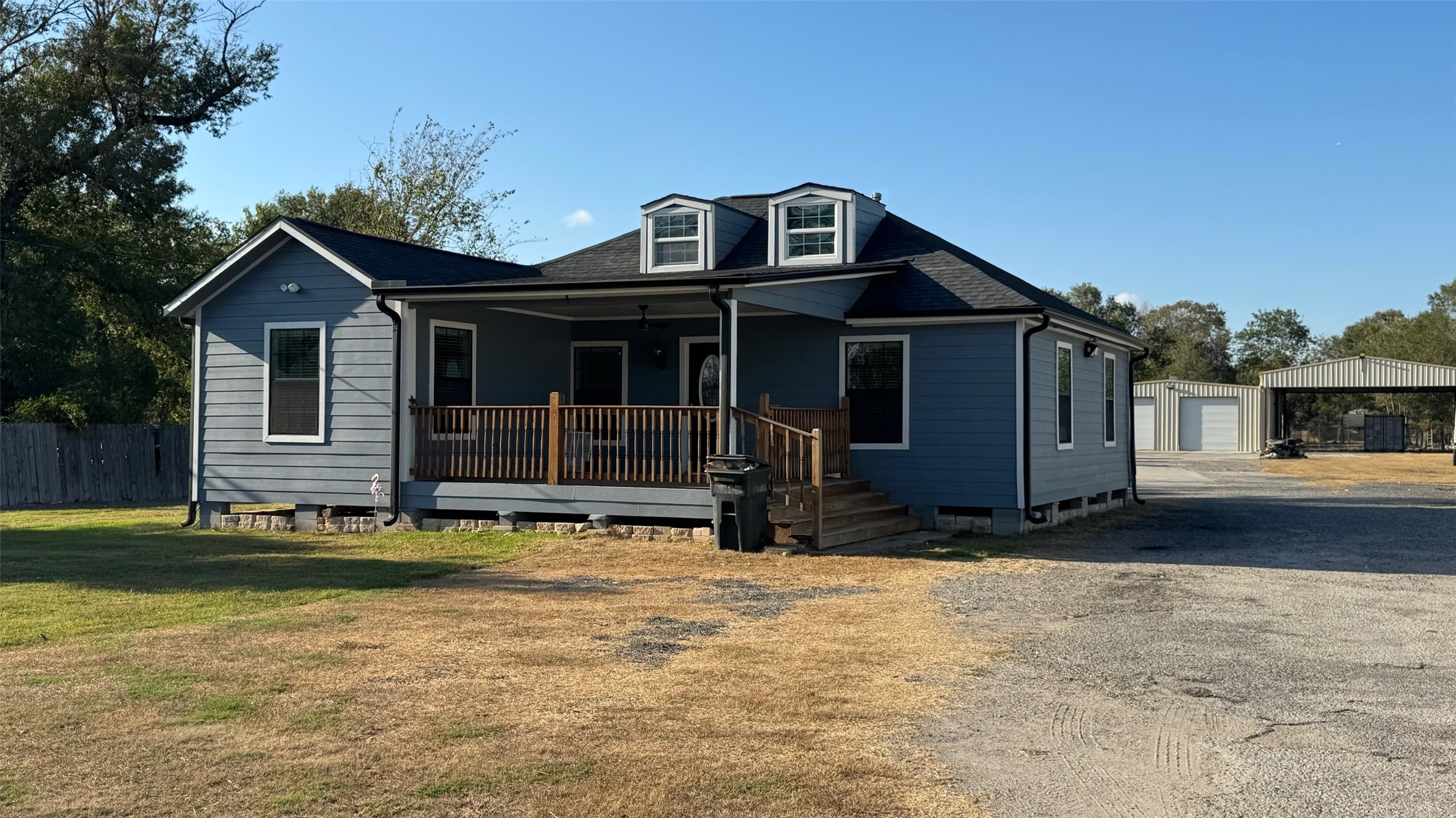 a view of a house with wooden deck and a yard