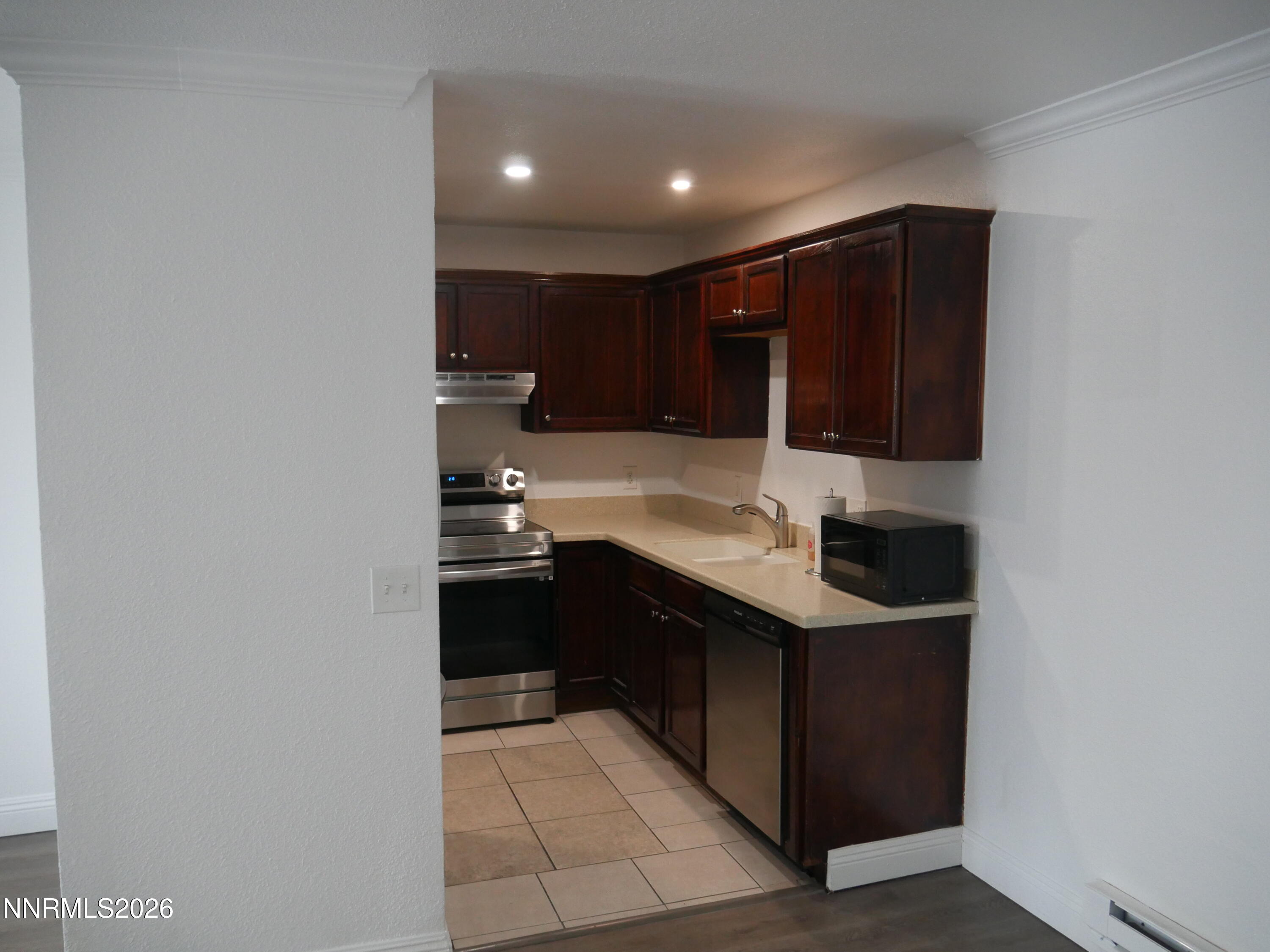 2385 Tripp Drive, Unit 3 Reno, NV 89512 - Photo 20 of 49 a kitchen with kitchen island granite countertop a sink and cabinets
