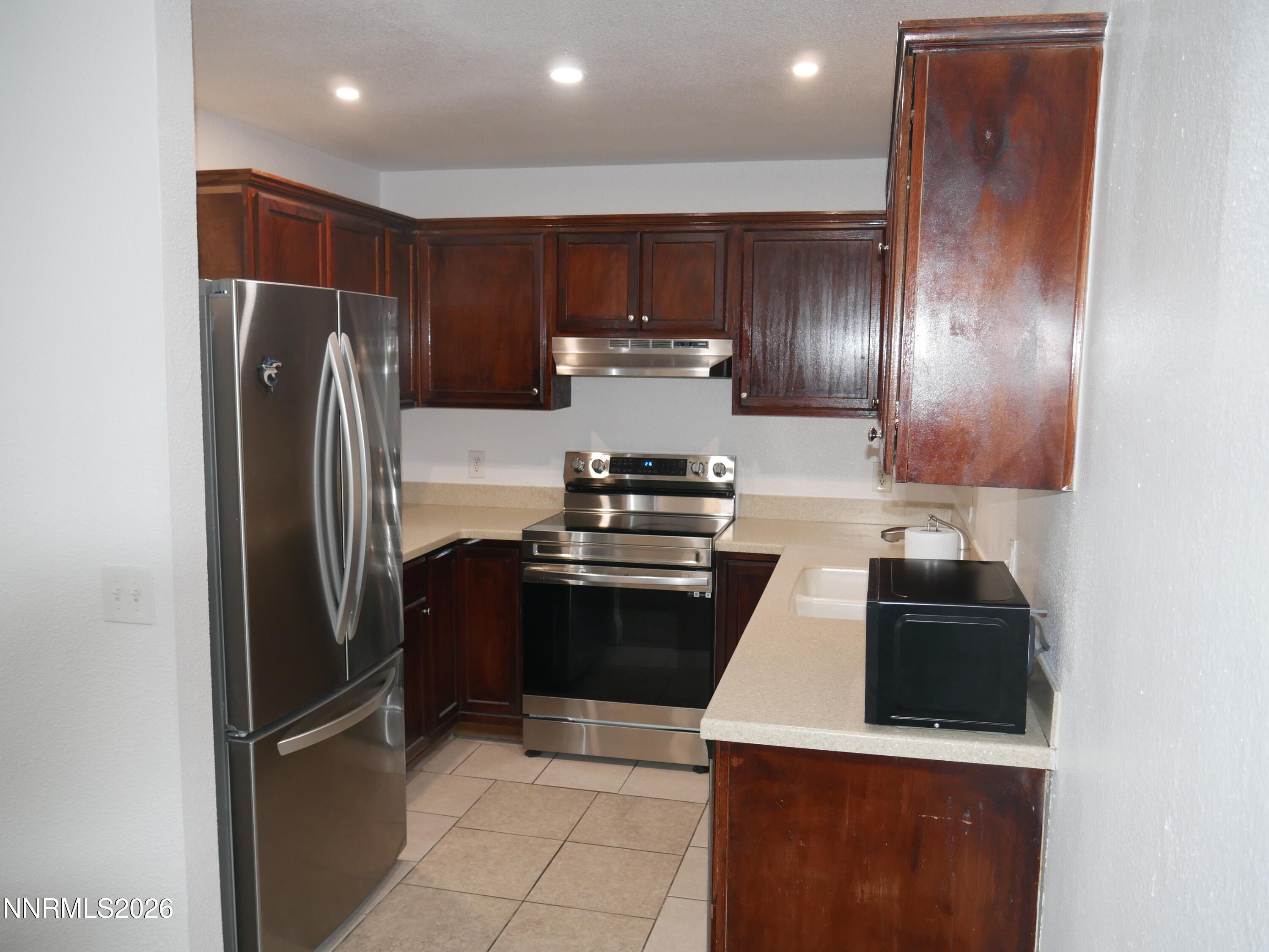 2385 Tripp Drive, Unit 3 Reno, NV 89512 - Photo 23 of 49 a kitchen with stainless steel appliances granite countertop a refrigerator and a stove