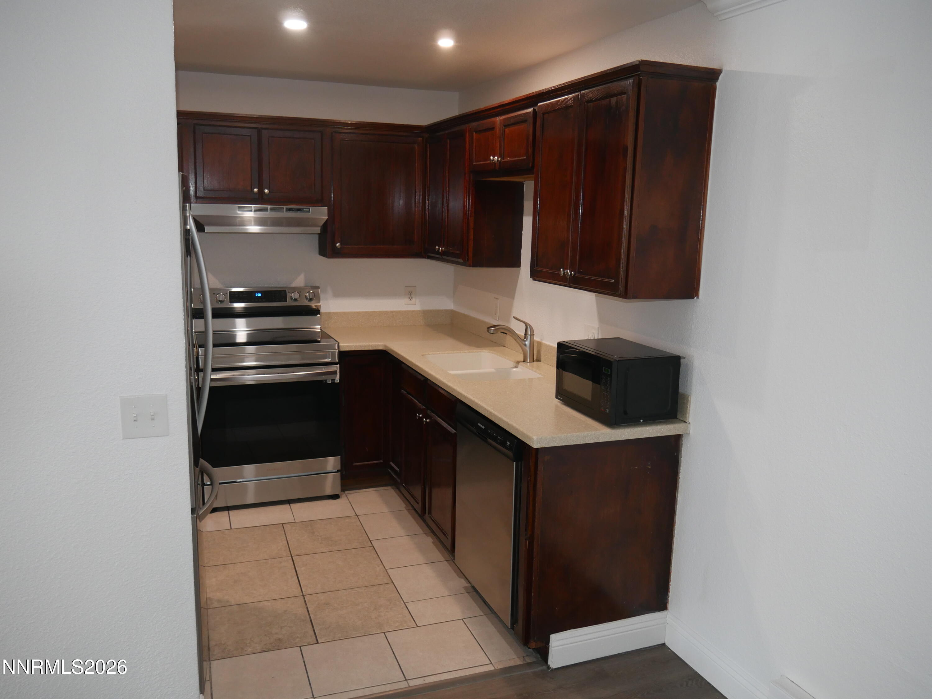 2385 Tripp Drive, Unit 3 Reno, NV 89512 - Photo 25 of 49 a kitchen with a sink and a refrigerator