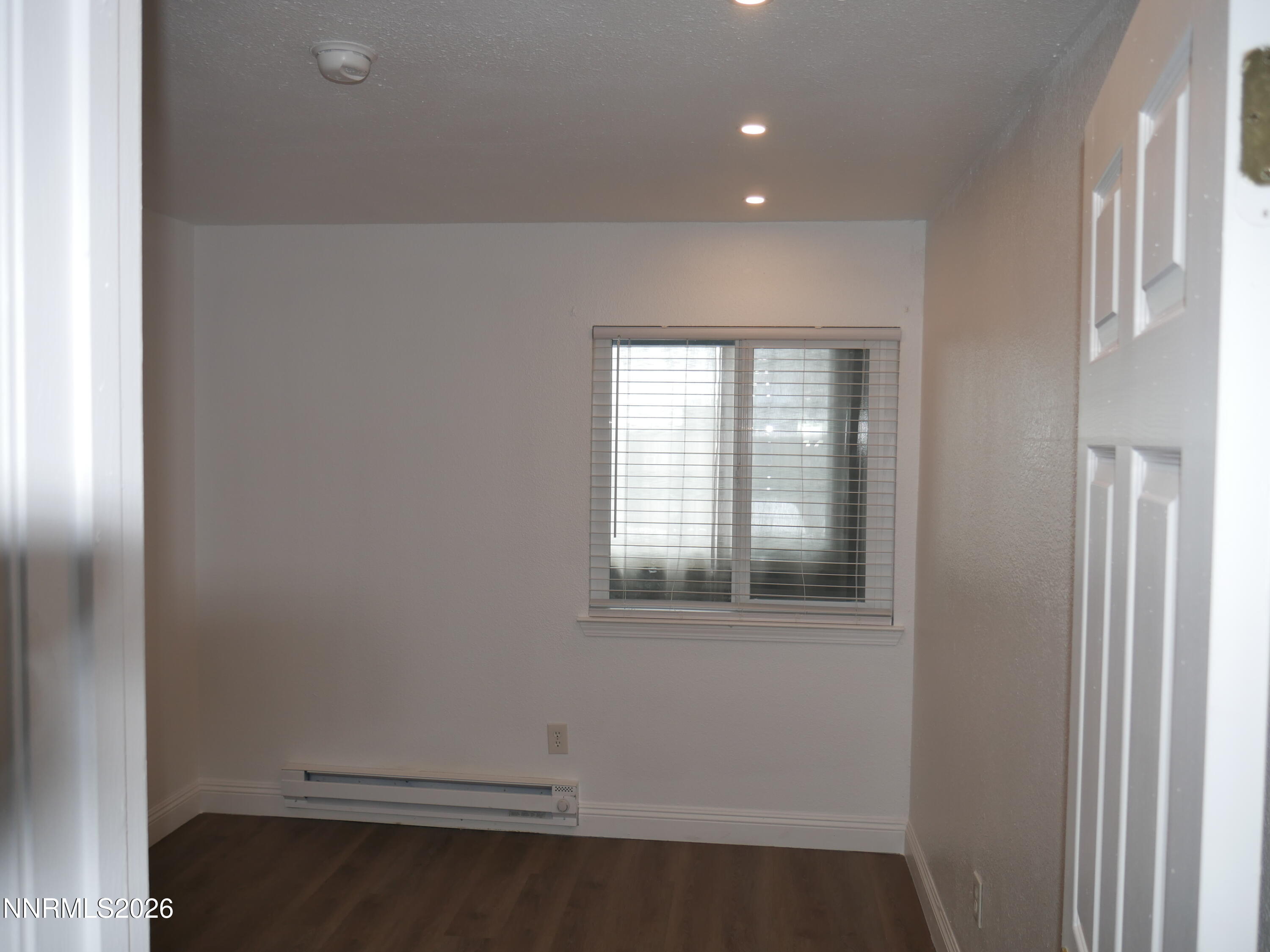 2385 Tripp Drive, Unit 3 Reno, NV 89512 - Photo 27 of 49 a view of an empty room with wooden floor and a window