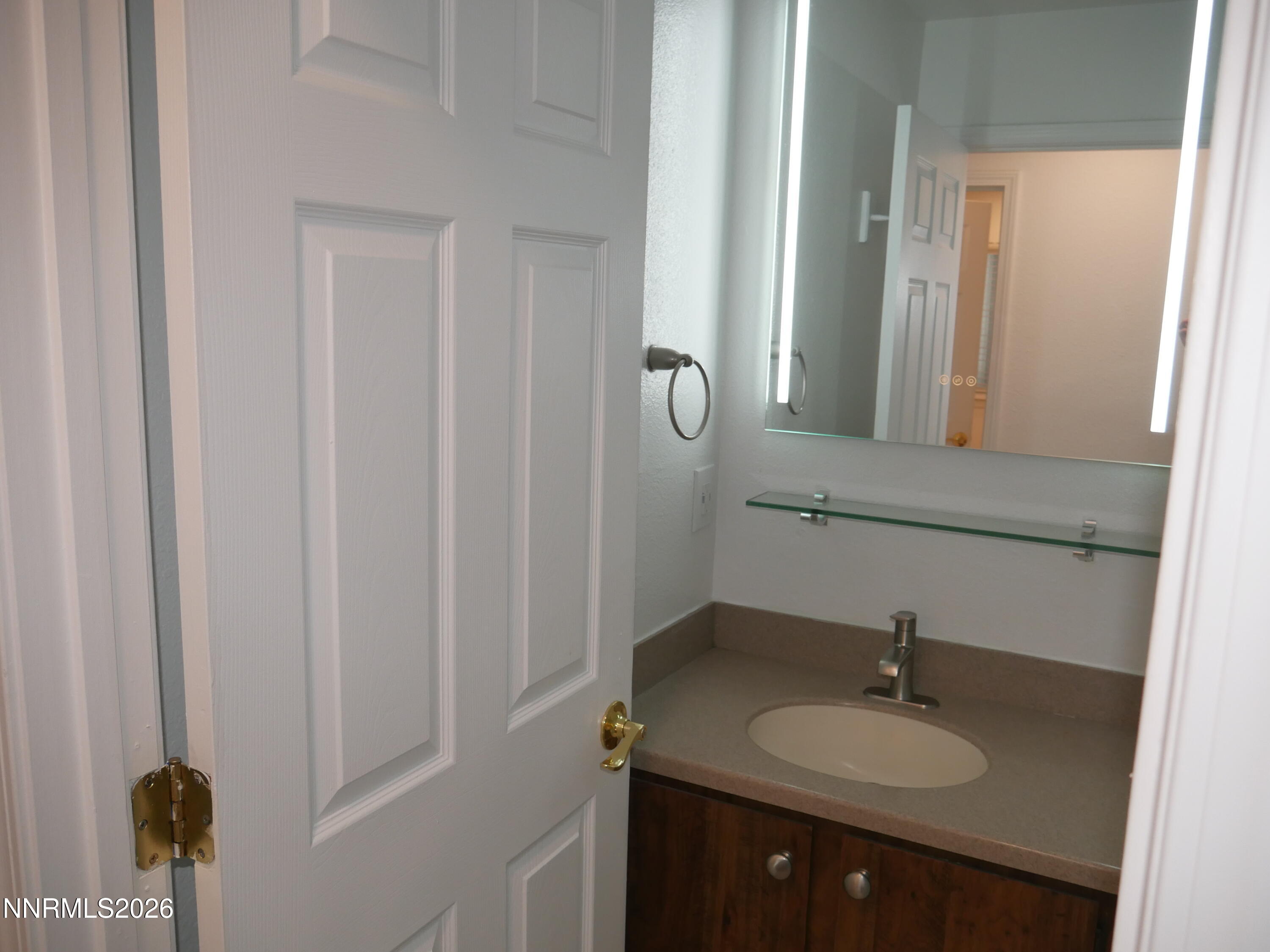 2385 Tripp Drive, Unit 3 Reno, NV 89512 - Photo 32 of 49 a bathroom with a granite countertop sink and a mirror