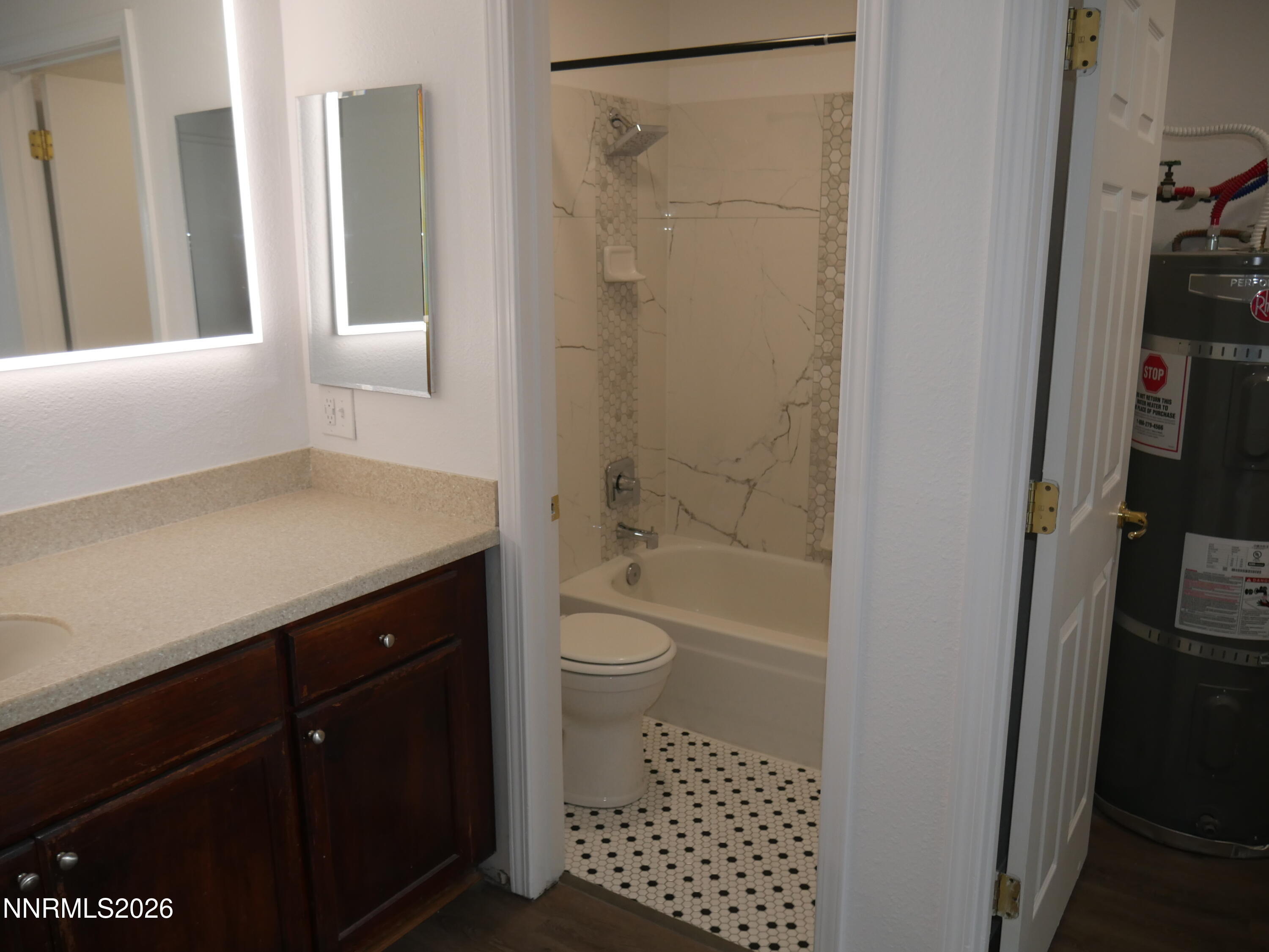 2385 Tripp Drive, Unit 3 Reno, NV 89512 - Photo 37 of 49 a bathroom with a granite countertop sink toilet and shower