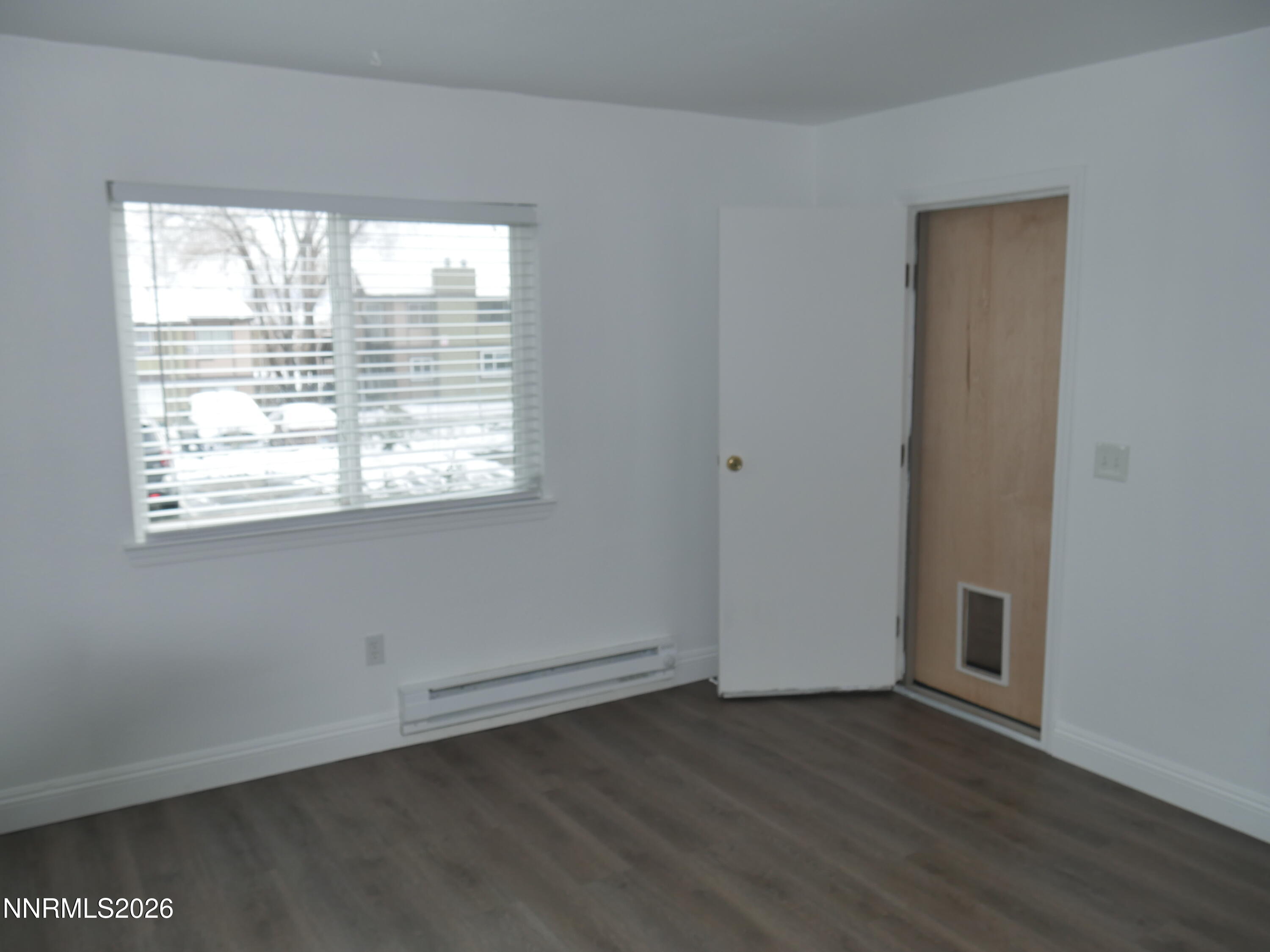 2385 Tripp Drive, Unit 3 Reno, NV 89512 - Photo 42 of 49 an empty room with wooden floor and windows