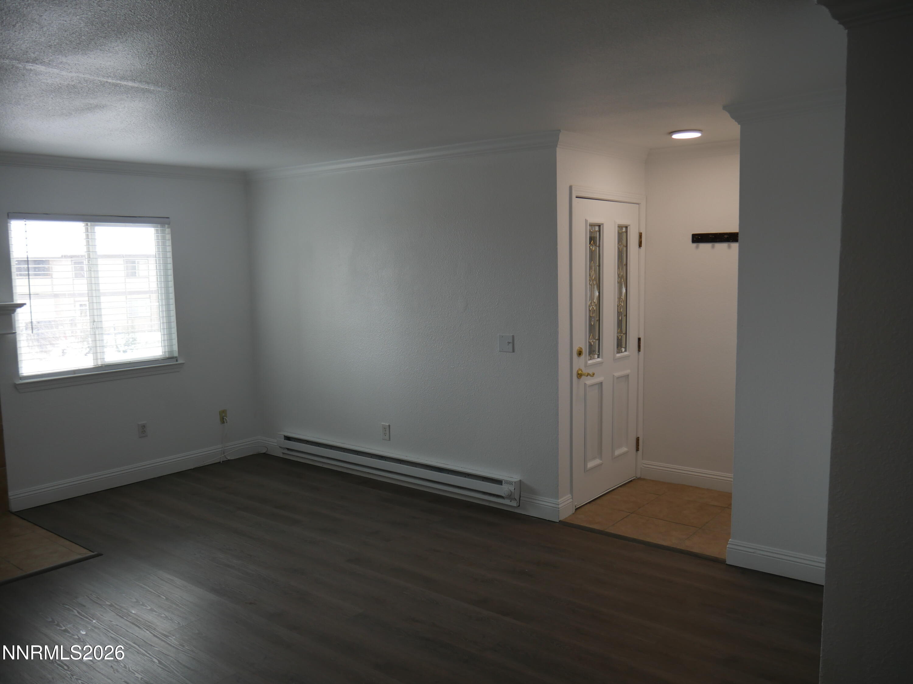 2385 Tripp Drive, Unit 3 Reno, NV 89512 - Photo 8 of 49 an empty room with wooden floor and windows