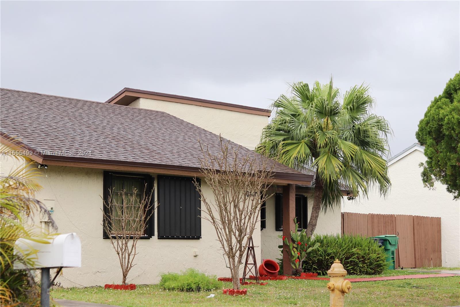 20640 Southwest 124th Court Miami, FL 33177 - Photo 1 of 2 a front view of a house with garden