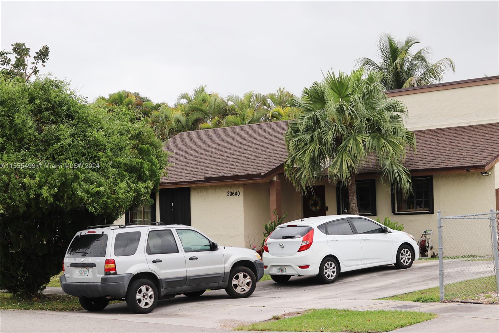 20640 Southwest 124th Court Miami, FL 33177 - Photo 2 of 2 a view of cars parked in front of a house