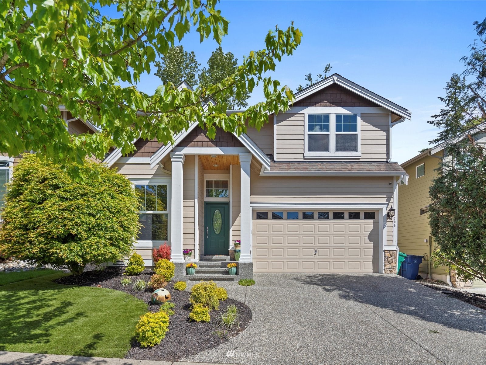 1705 235th Place Southwest Bothell, WA 98021 - Photo 1 of 35 a front view of a house with a yard and garage