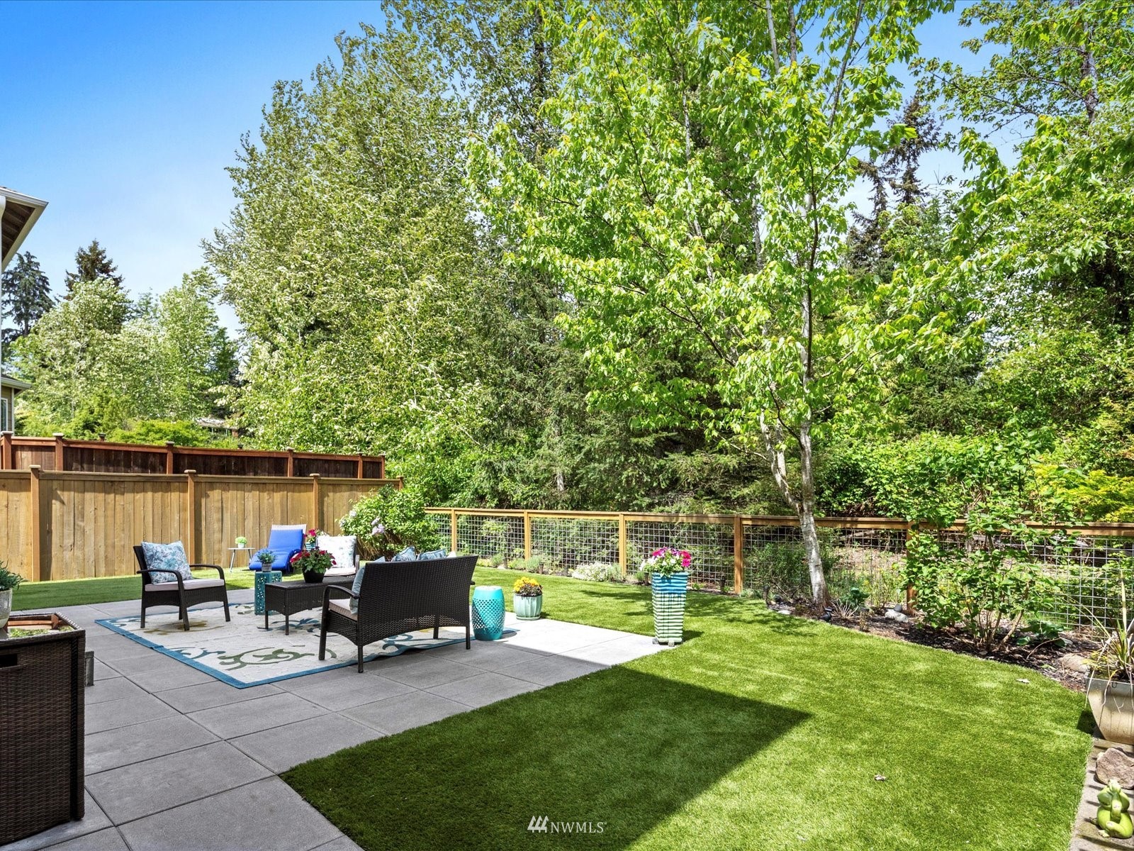 1705 235th Place Southwest Bothell, WA 98021 - Photo 31 of 35 a view of a patio with table and chairs potted plants with large tree