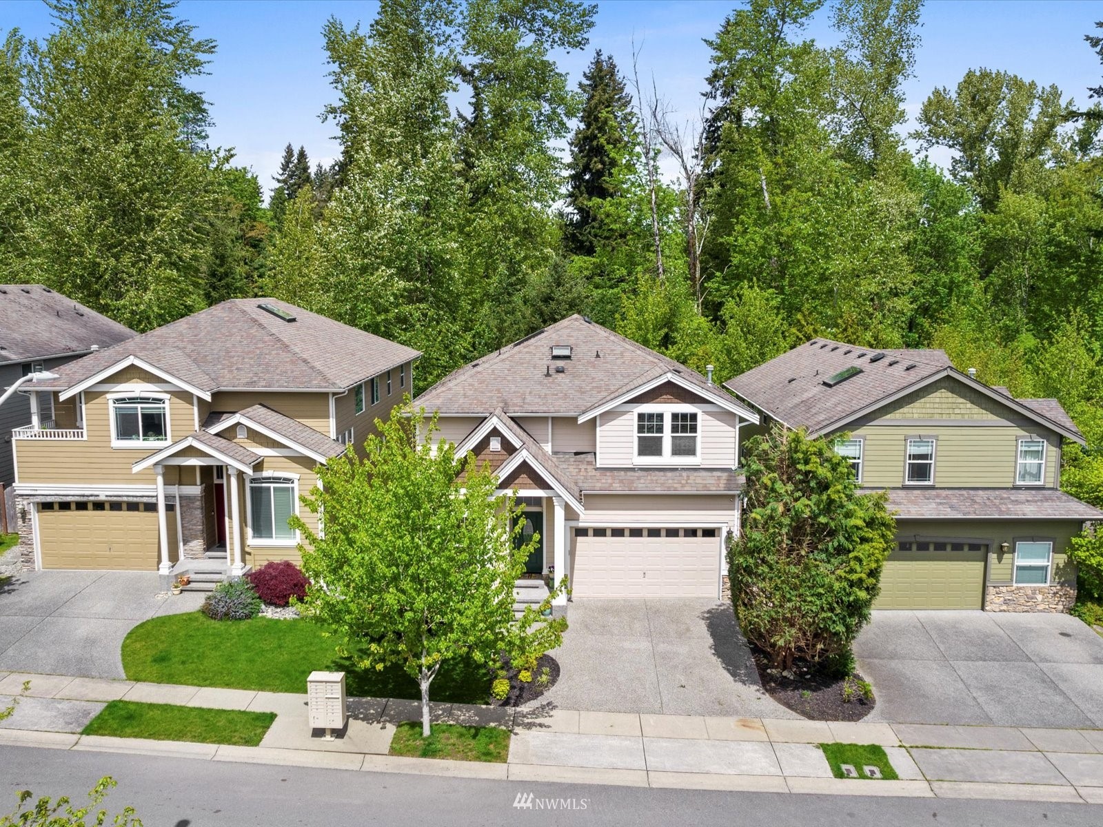 1705 235th Place Southwest Bothell, WA 98021 - Photo 33 of 35 a front view of a house with a garden