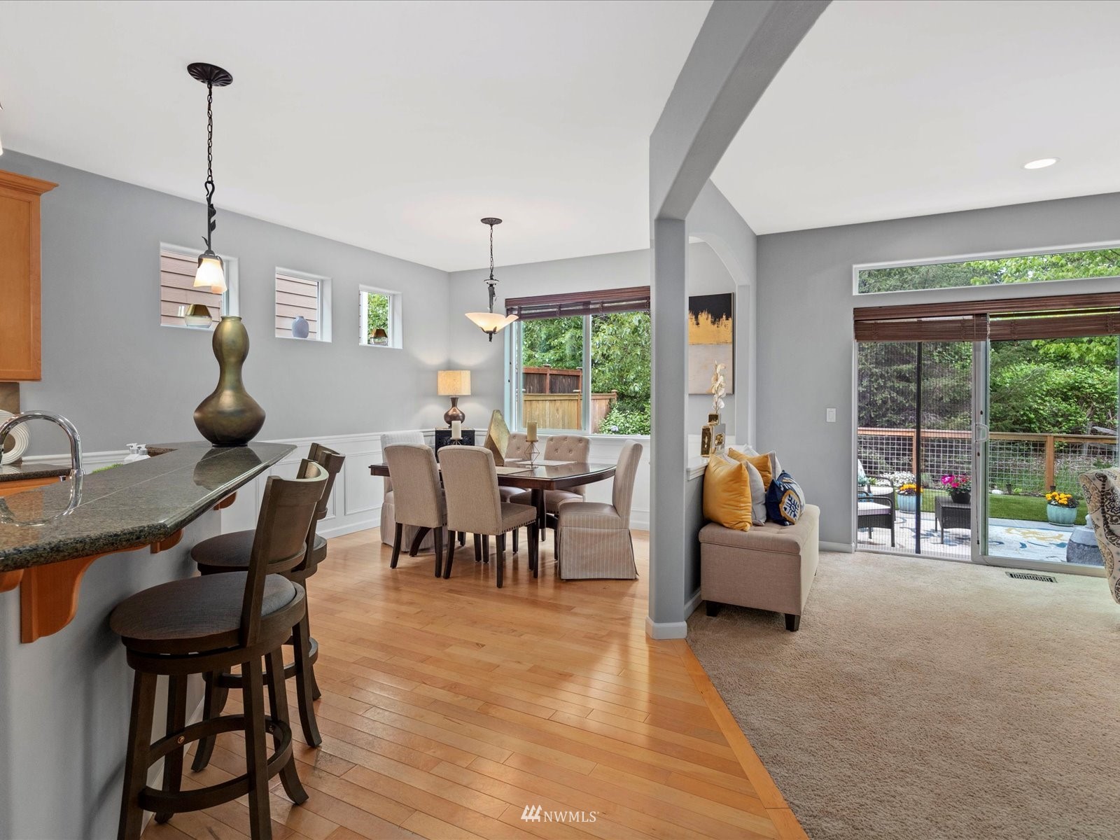 1705 235th Place Southwest Bothell, WA 98021 - Photo 9 of 35 a view of a dining room and livingroom with furniture wooden floor a chandelier