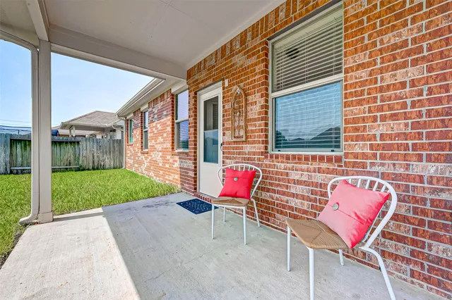 a backyard of a house with outdoor seating