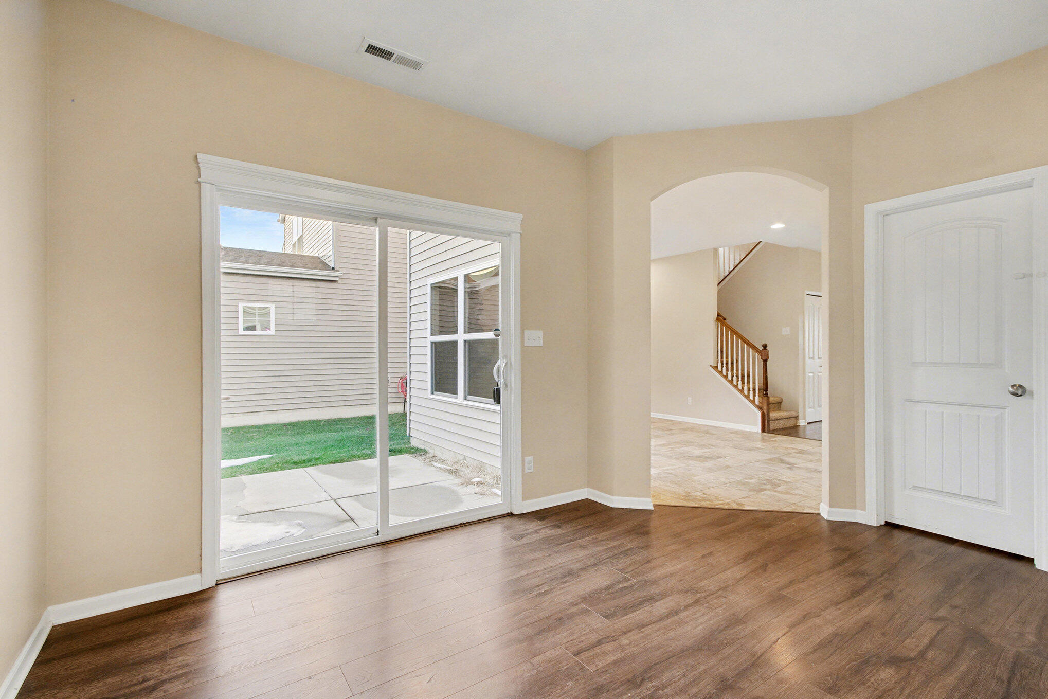 1063 East 116th Place Crown Point, IN 46307 - Photo 12 of 24 an empty room with wooden floor and windows