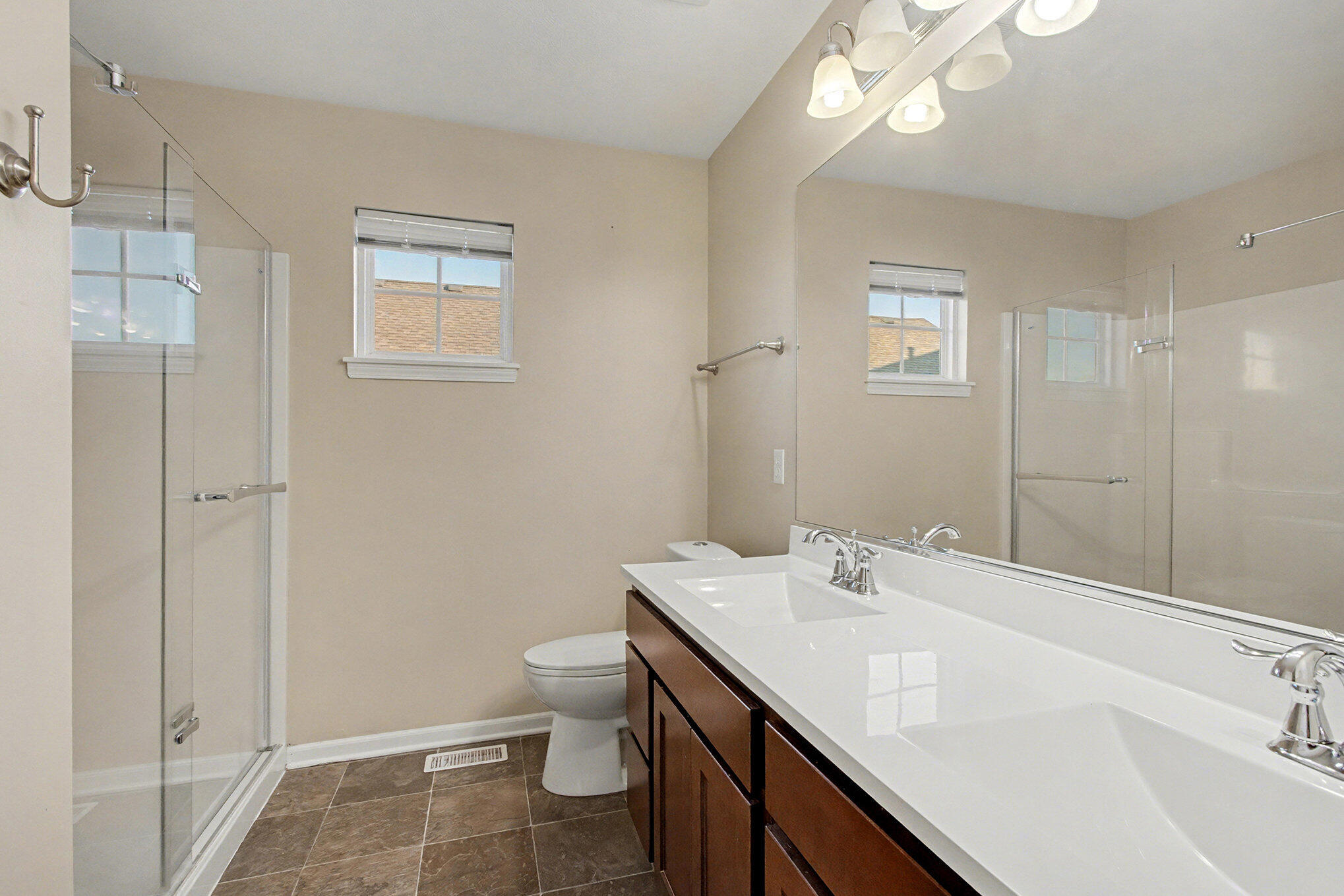 1063 East 116th Place Crown Point, IN 46307 - Photo 17 of 24 a bathroom with a sink a toilet and shower