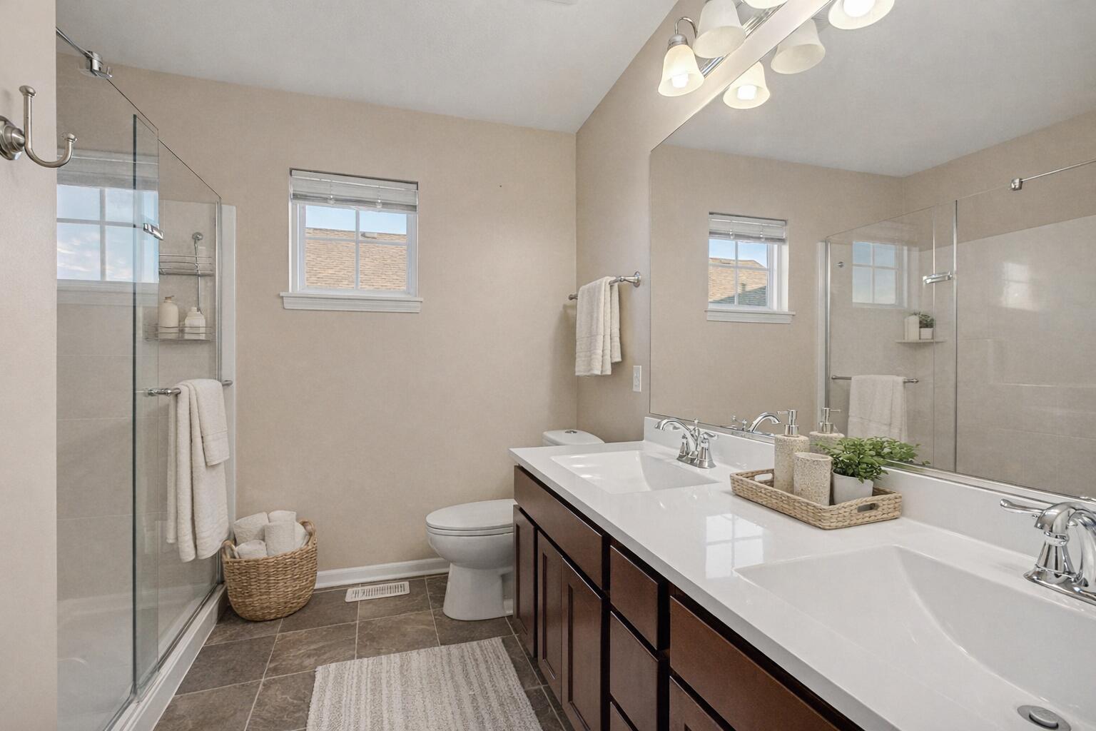 1063 East 116th Place Crown Point, IN 46307 - Photo 17 of 24 a bathroom with a double vanity sink toilet and a mirror