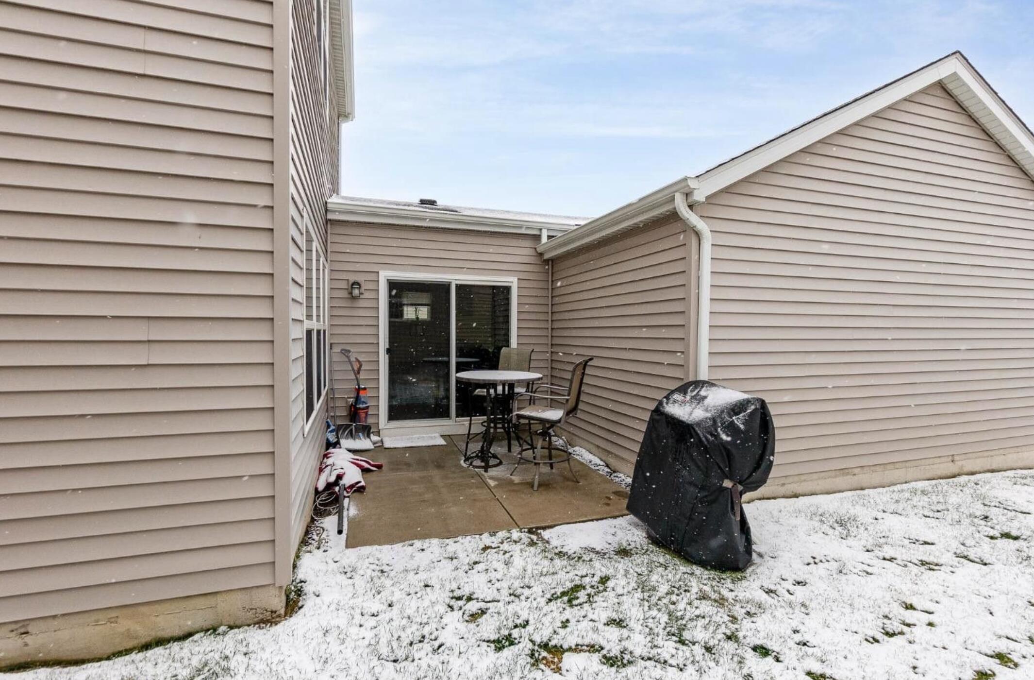 1063 East 116th Place Crown Point, IN 46307 - Photo 5 of 24 a table and chairs in front of a house