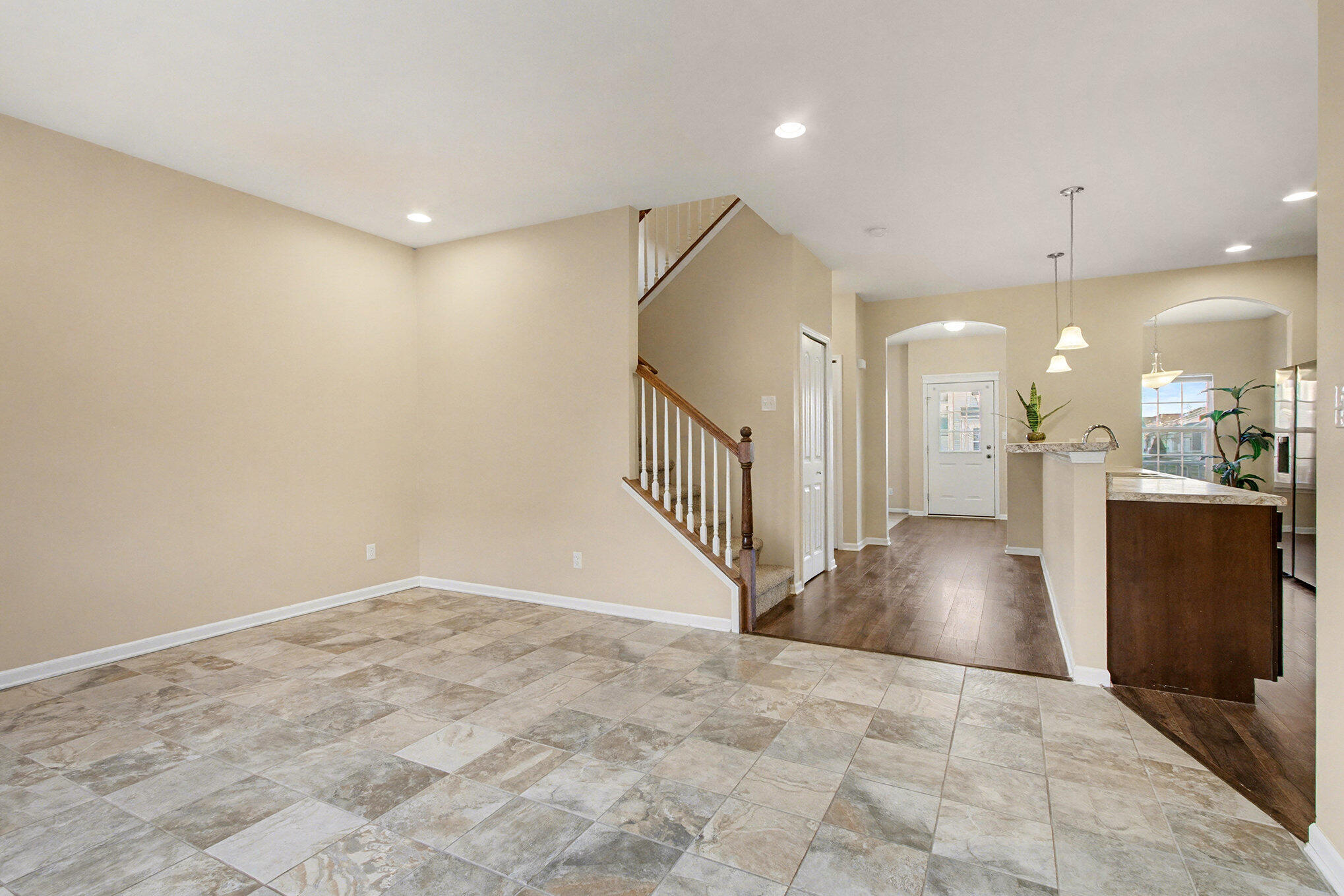 1063 East 116th Place Crown Point, IN 46307 - Photo 9 of 24 a view of a hallway with wooden floor and a kitchen