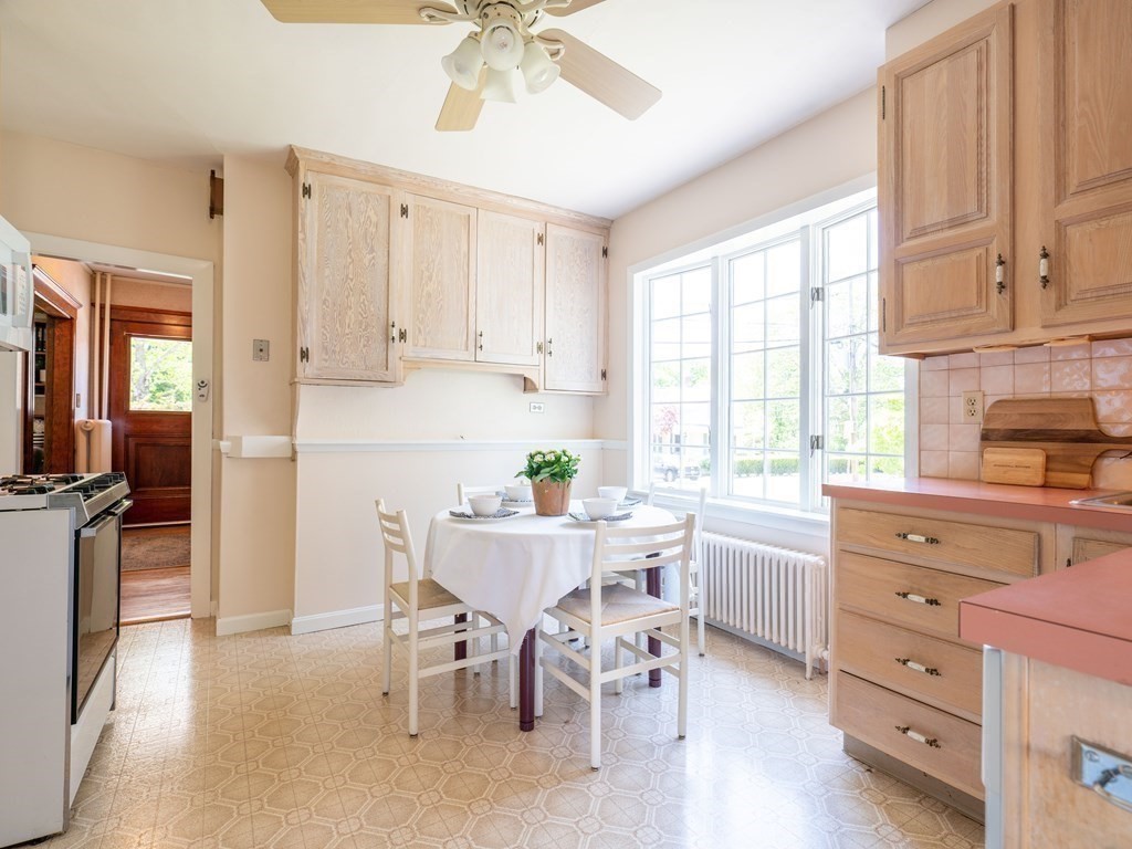 82 Oak Street Lexington, MA 02421 - Photo 11 of 31 a kitchen with a stove a refrigerator and white cabinets