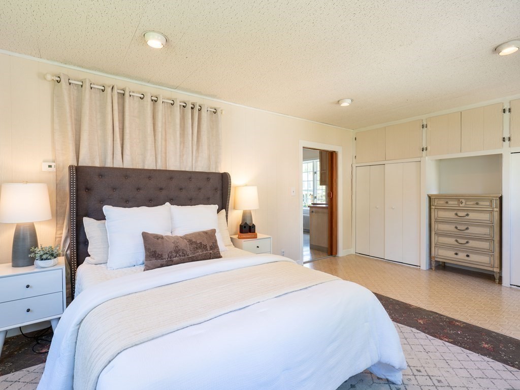 82 Oak Street Lexington, MA 02421 - Photo 15 of 31 a bedroom with a large bed and a tv