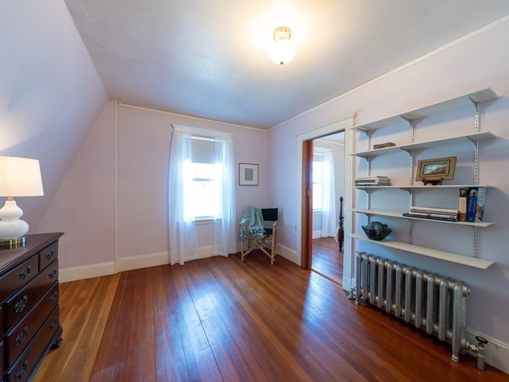 82 Oak Street Lexington, MA 02421 - Photo 22 of 31 a view of a room with wooden floor windows and a kitchen