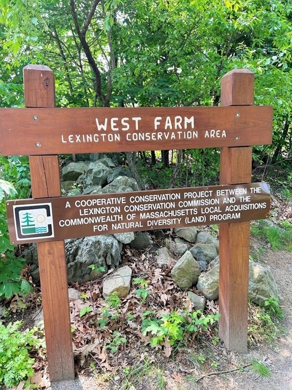 82 Oak Street Lexington, MA 02421 - Photo 29 of 31 a sign that is sitting on a wooden fence