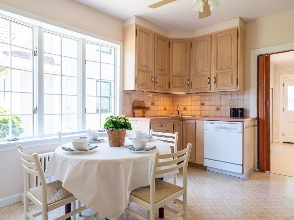 82 Oak Street Lexington, MA 02421 - Photo 9 of 31 a kitchen with a white table chairs and a window