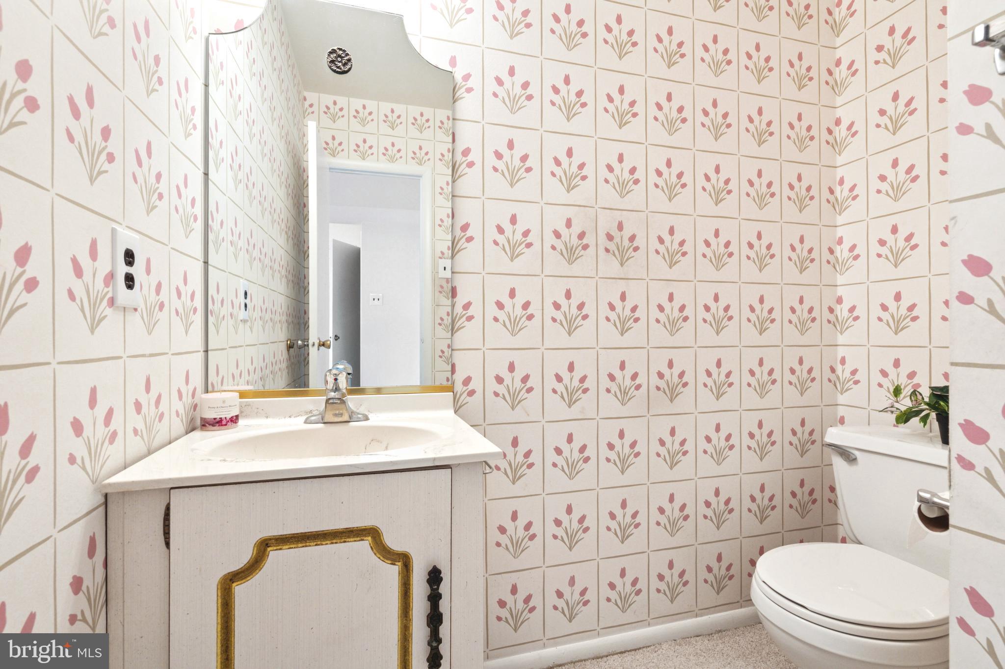 700 Ardmore Avenue, Unit 621 Ardmore, PA 19003 - Photo 13 of 37 a bathroom with a sink a toilet and a mirror