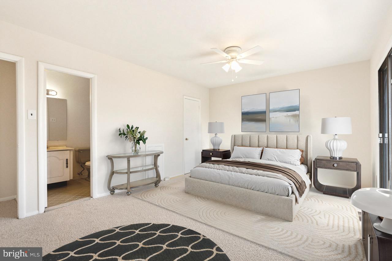 700 Ardmore Avenue, Unit 621 Ardmore, PA 19003 - Photo 15 of 37 a spacious bedroom with a bed and a chandelier