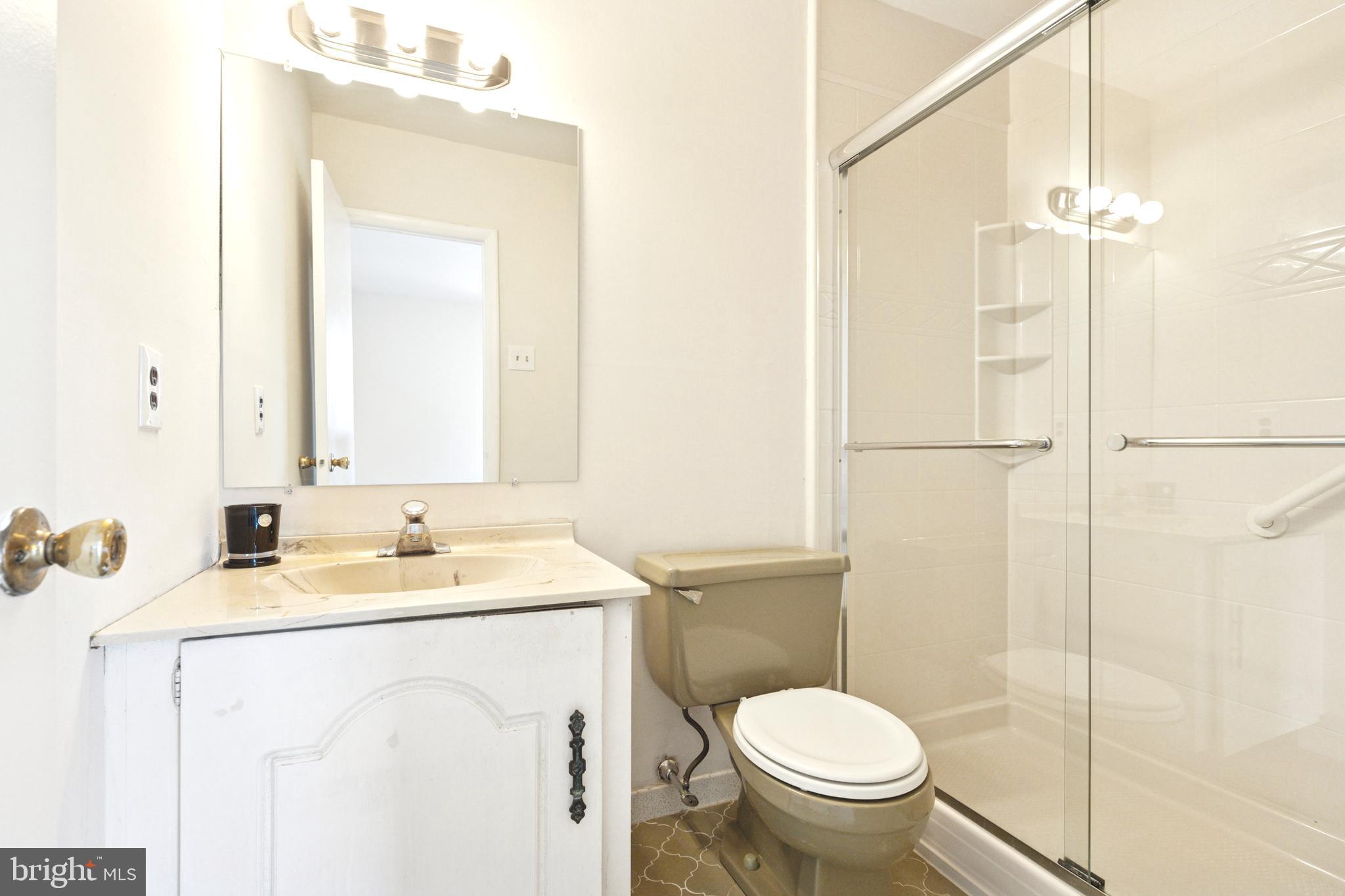 700 Ardmore Avenue, Unit 621 Ardmore, PA 19003 - Photo 19 of 37 a bathroom with a sink toilet and shower