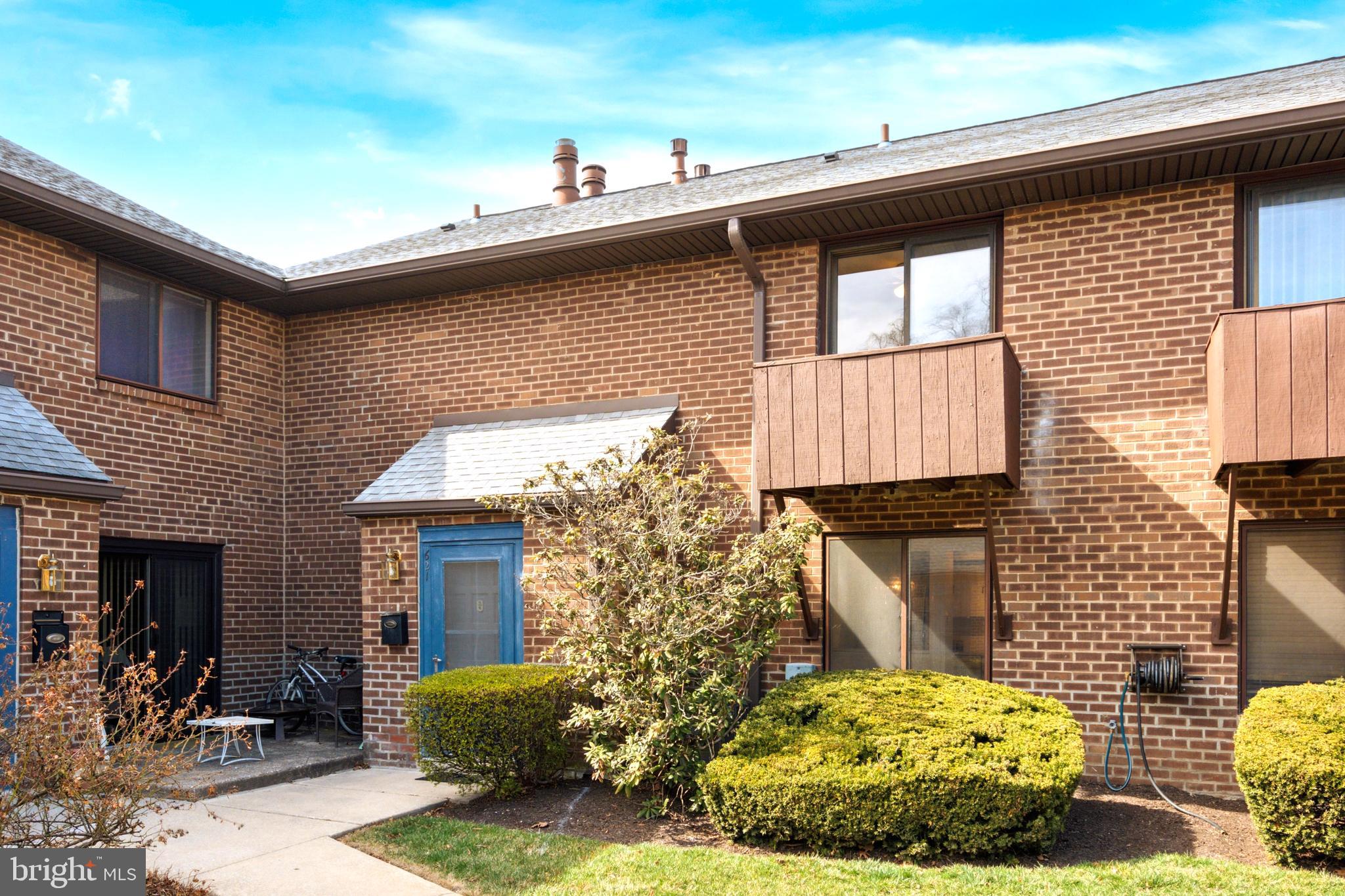 700 Ardmore Avenue, Unit 621 Ardmore, PA 19003 - Photo 28 of 37 a brick house with potted plants and wooden fence