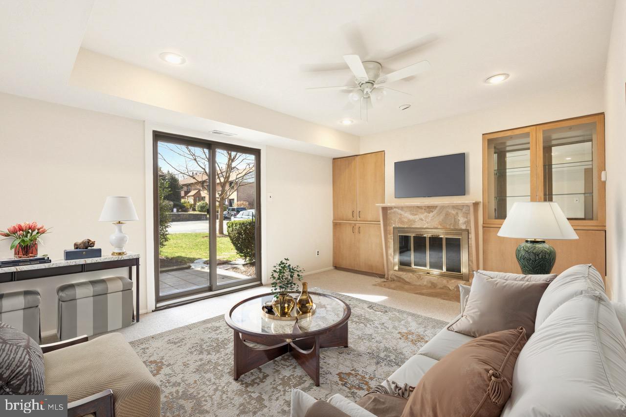 700 Ardmore Avenue, Unit 621 Ardmore, PA 19003 - Photo 3 of 37 a living room with furniture a fireplace and a flat screen tv