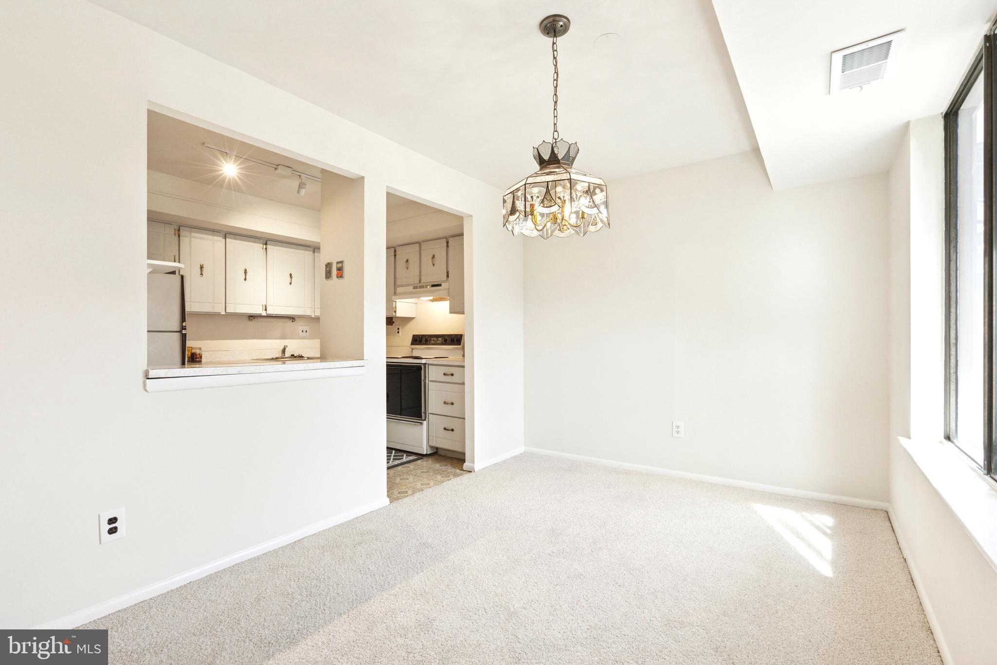 700 Ardmore Avenue, Unit 621 Ardmore, PA 19003 - Photo 7 of 37 a view of a hallway with a kitchen