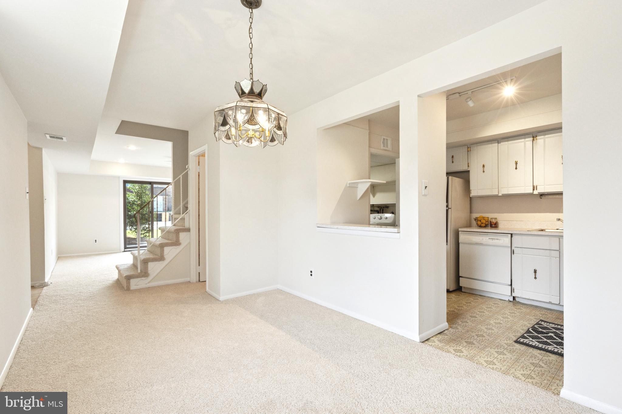 700 Ardmore Avenue, Unit 621 Ardmore, PA 19003 - Photo 8 of 37 a view of a kitchen with a refrigerator a stove top oven and cabinets