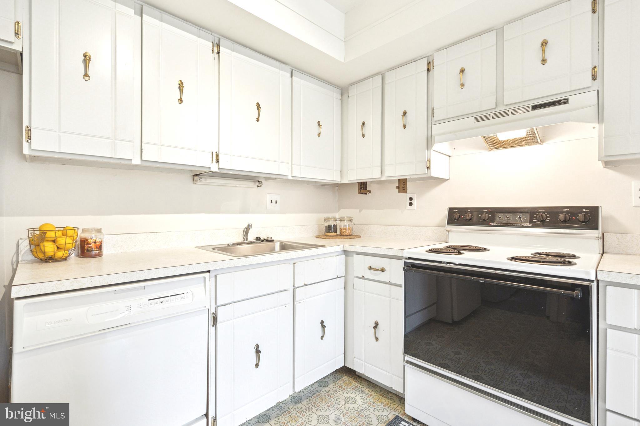 700 Ardmore Avenue, Unit 621 Ardmore, PA 19003 - Photo 9 of 37 a kitchen with cabinets appliances a sink and a counter top